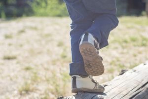 Boy walking on log